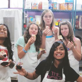 Kids enjoying cupcakes in bakery shop west lake village